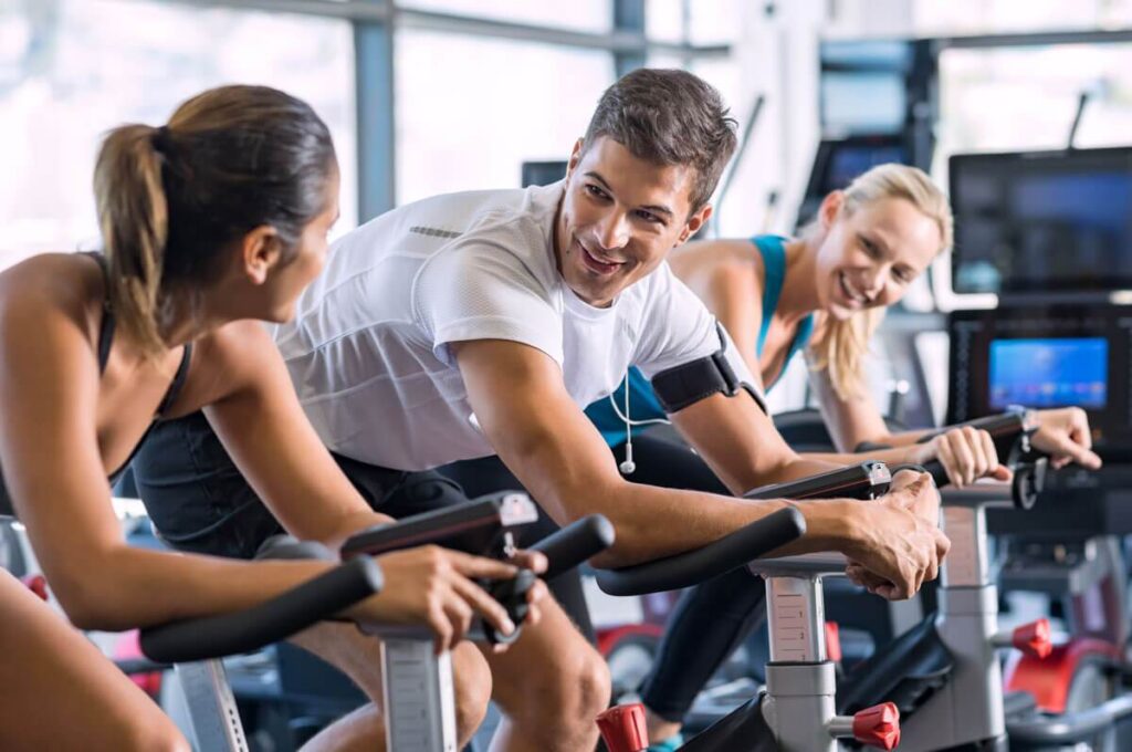 fit-people-cycling-at-gym